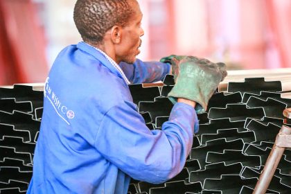 RM Wispeco employee stacking tin roofs